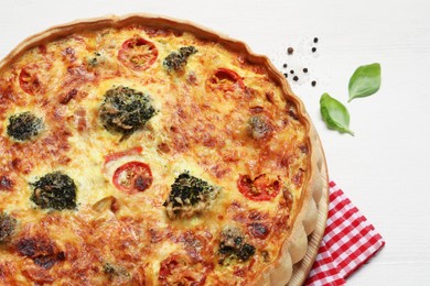 Photo of Delicious homemade vegetable quiche on white table, closeup