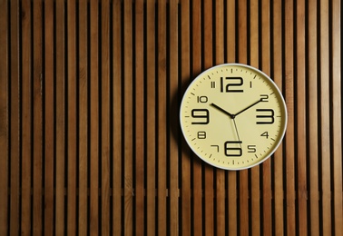 Photo of Stylish clock and space for text on wooden background. Time management