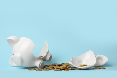 Broken piggy bank with money on color background