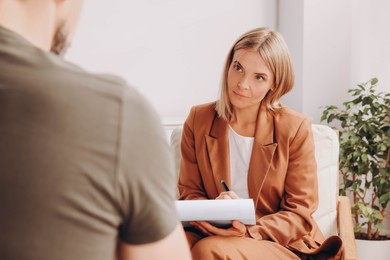 Photo of Psychologist working with military officer in office