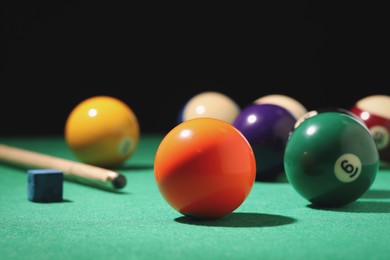 Photo of Many colorful billiard balls on green table