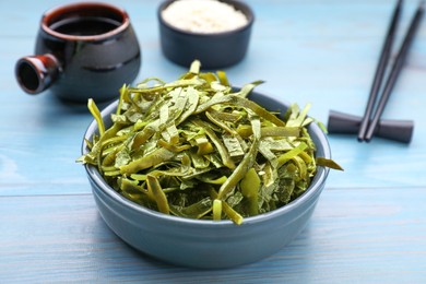 Fresh laminaria (kelp) seaweed served on light blue wooden table