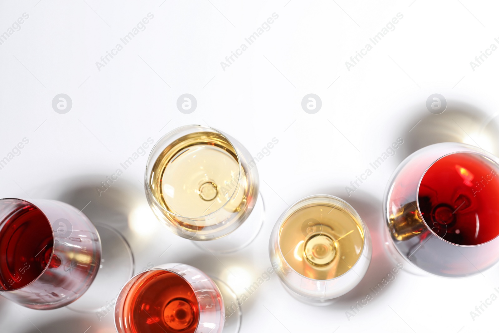 Photo of Different glasses with wine on white background, top view