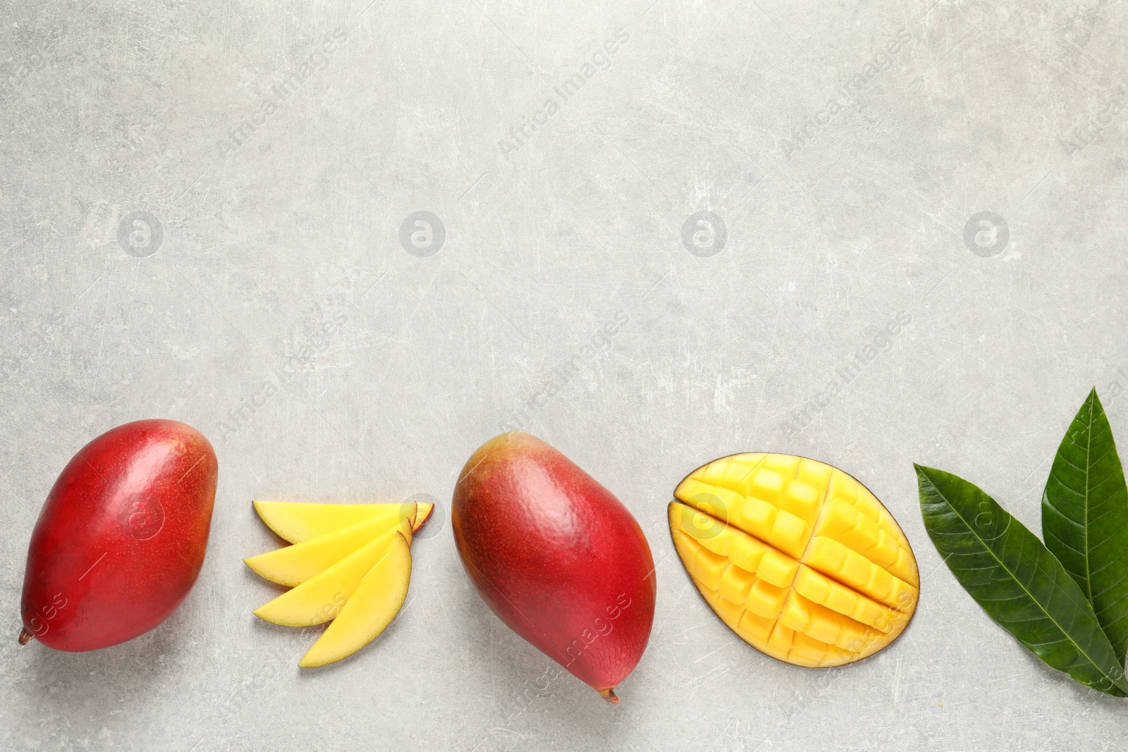 Photo of Flat lay composition with mango on grey background. Space for text