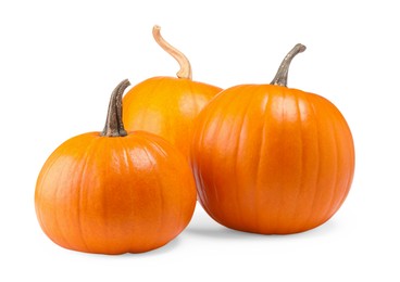 Photo of Many fresh orange pumpkins isolated on white