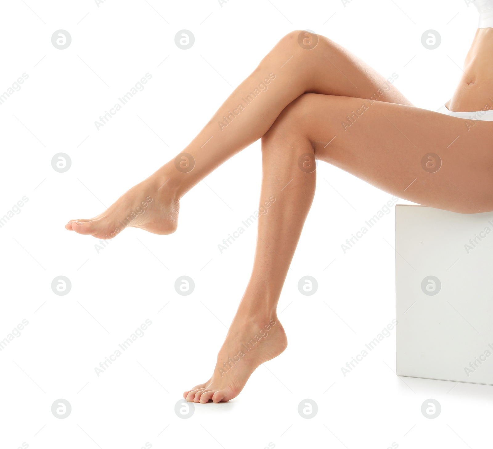 Photo of Young woman with beautiful long legs on white background, closeup