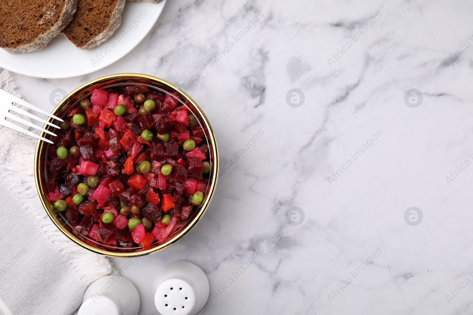 Photo of Delicious vinaigrette salad on white marble table, flat lay. Space for text