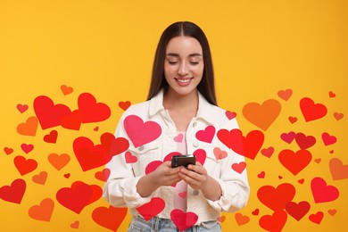 Long distance love. Woman chatting with sweetheart via smartphone on golden background. Hearts around her