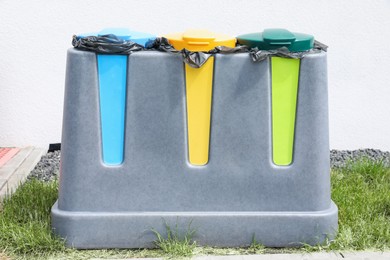 Photo of Recycling bins for different garbage outdoors. Waste sorting