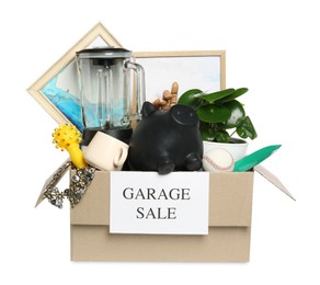 Photo of Different stuff in box with sign Garage Sale isolated on white