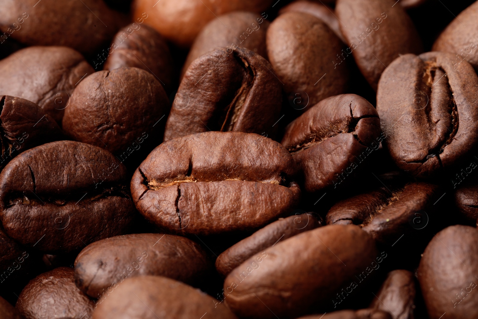 Photo of Aromatic roasted coffee beans as background, closeup