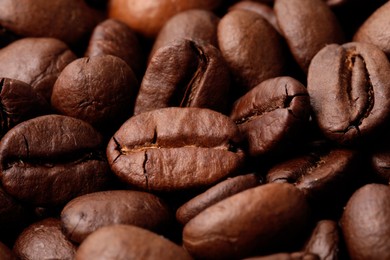 Aromatic roasted coffee beans as background, closeup