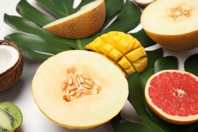 Juicy melon and other fruits on white background