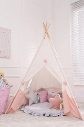 Cute child's room interior with toys, modern furniture and play tent