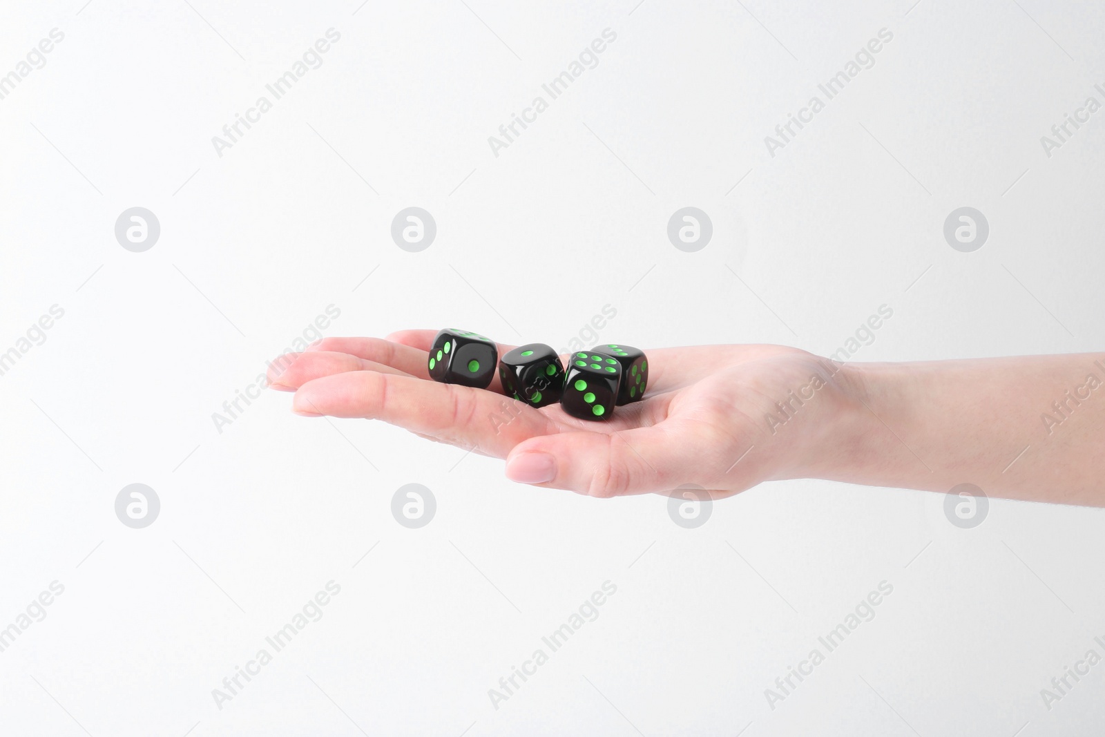 Photo of Woman holding game dices in hand on white background, closeup