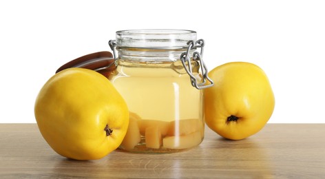 Delicious quince drink and fresh fruits on wooden table against white background