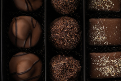 Photo of Many different chocolate candies in box, closeup