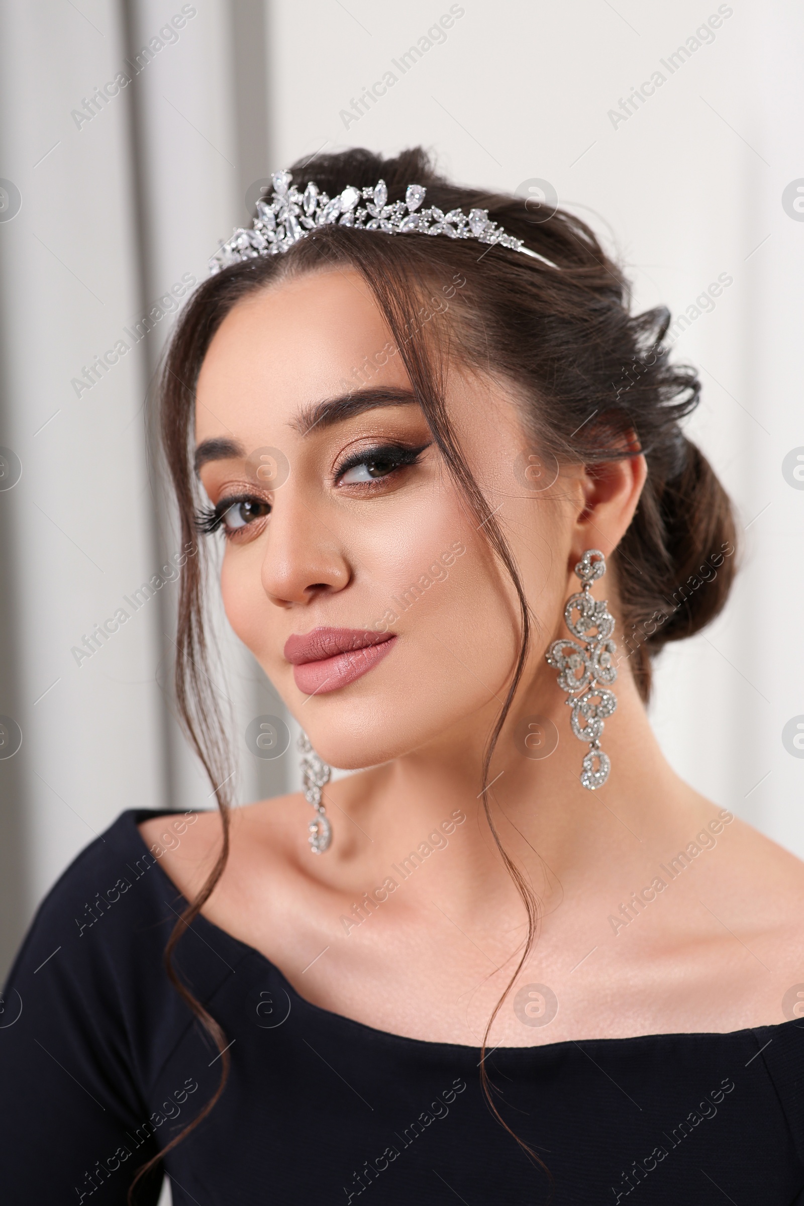 Photo of Beautiful young woman wearing luxurious tiara indoors