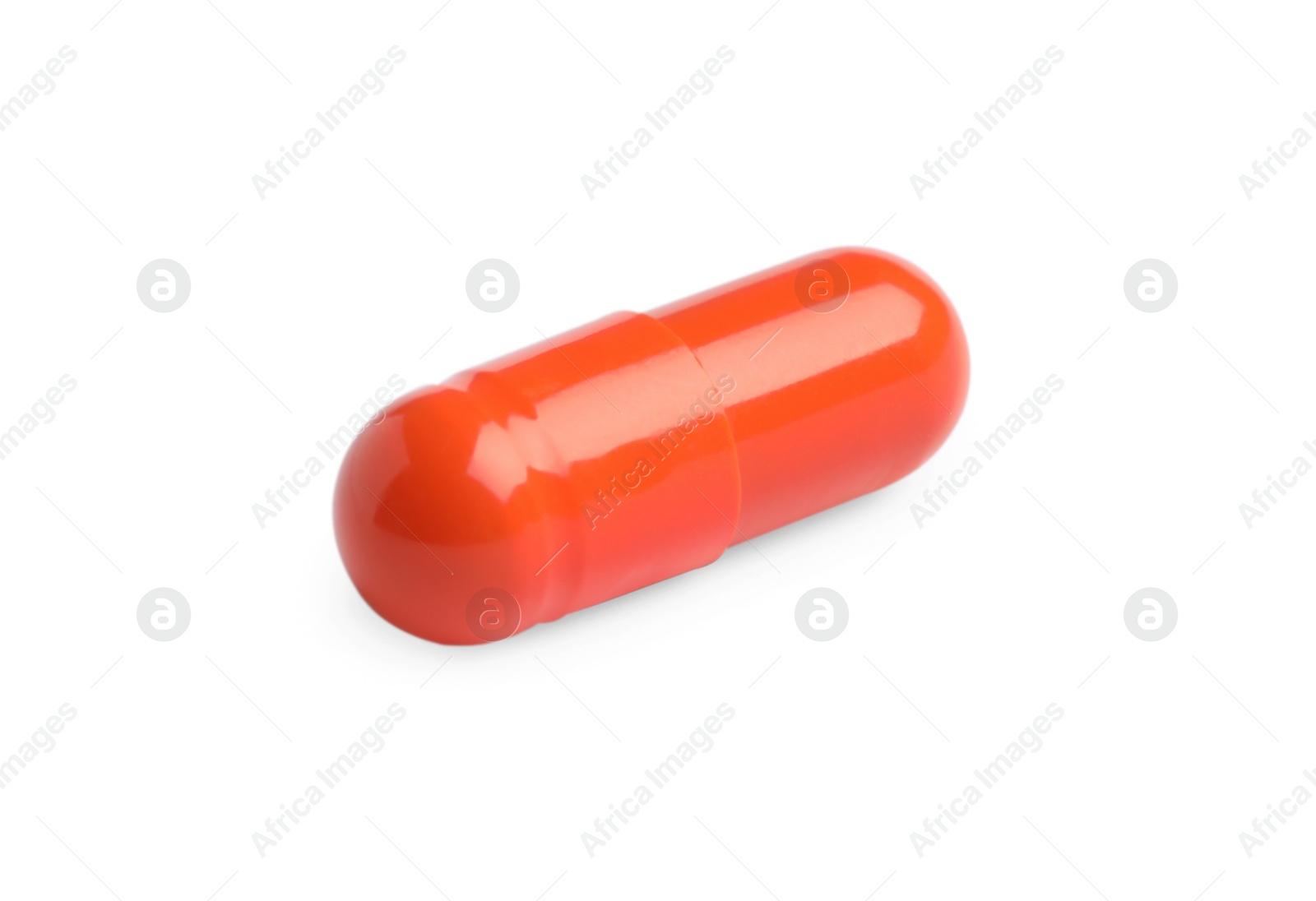 Photo of One orange pill on white background. Medicinal treatment