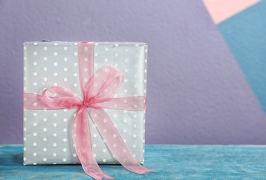 Photo of Elegant gift box with bow on table