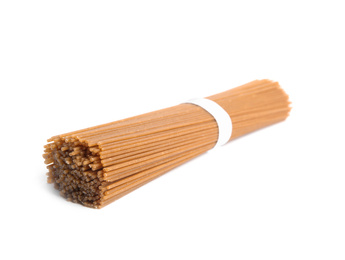 Photo of Uncooked buckwheat noodles isolated on white. Japanese cuisine