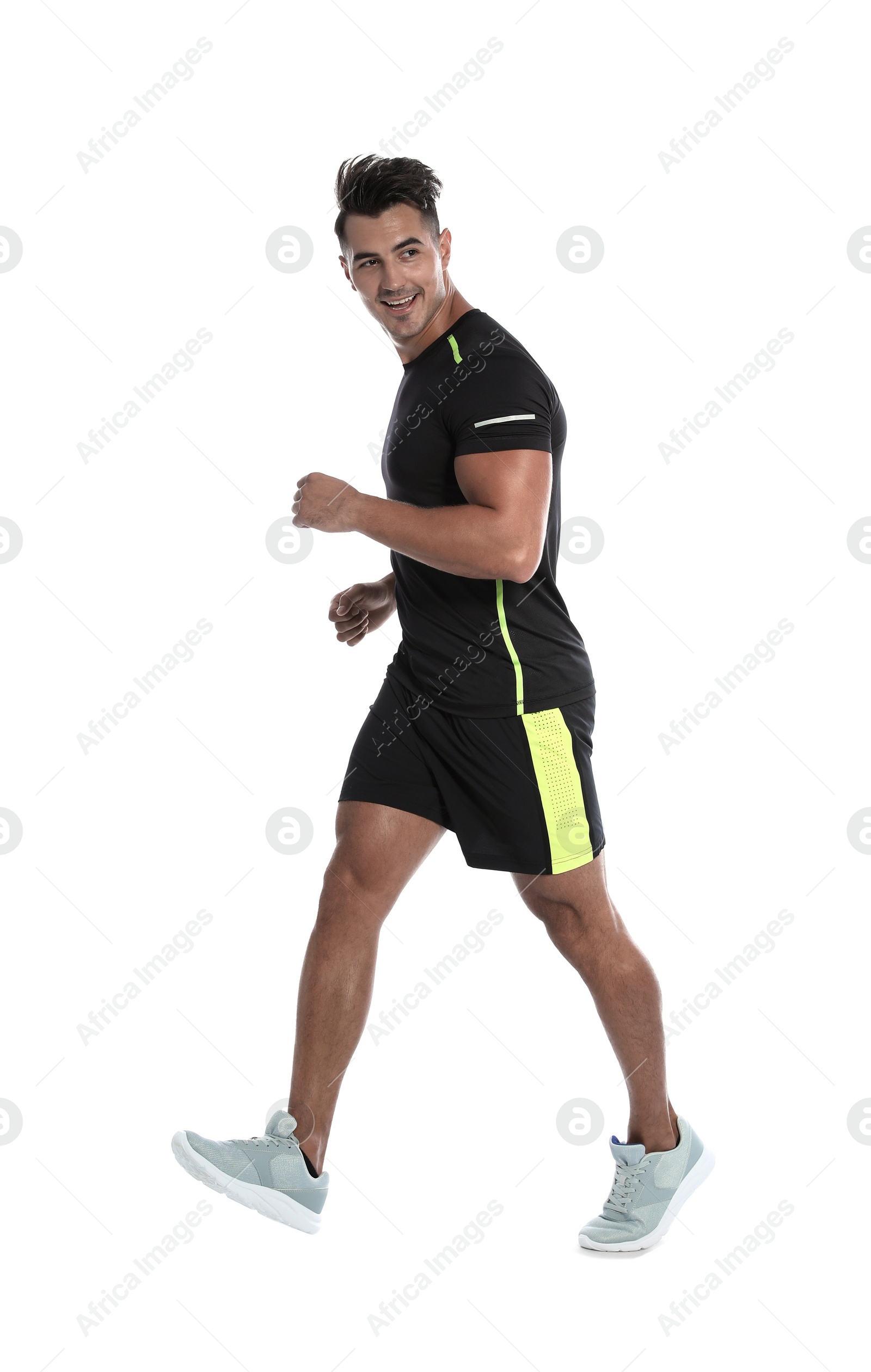 Photo of Sporty young man running on white background