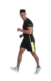 Photo of Sporty young man running on white background