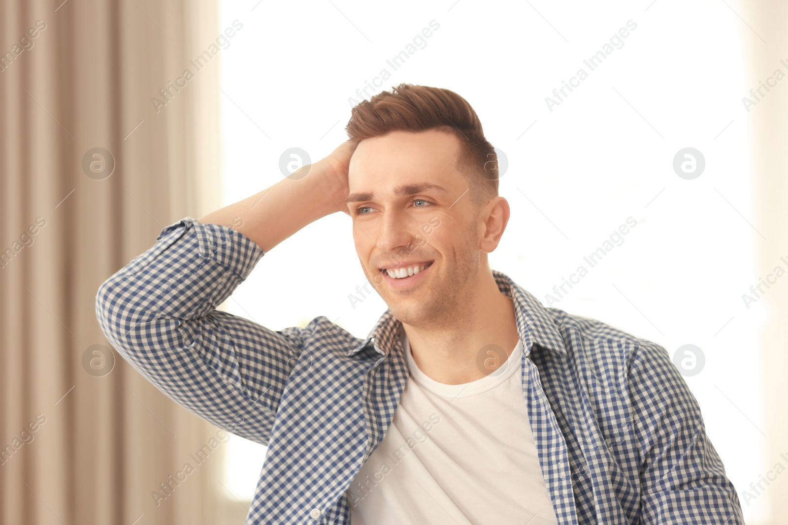 Photo of Portrait of young man with beautiful hair indoors