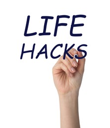 Image of Woman writing words Life Hacks with marker on glass board against white background, closeup