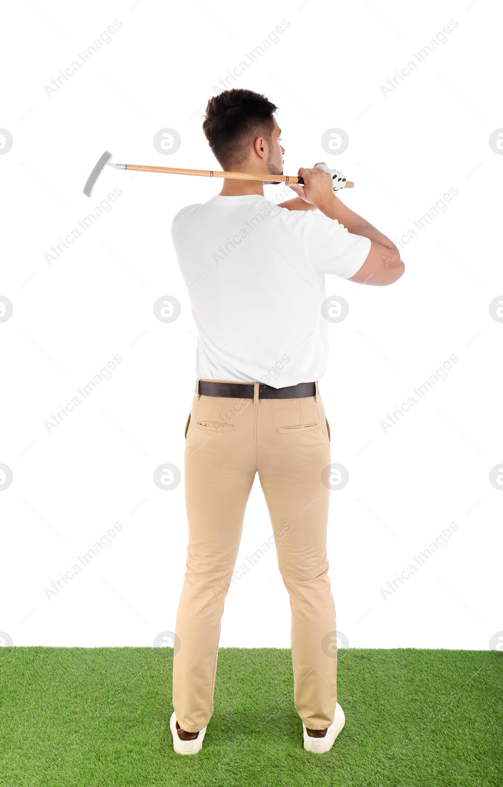 Photo of Young man playing golf on course against white background