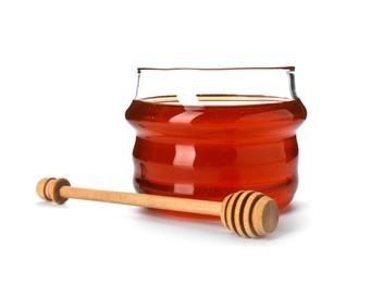 Jar with delicious honey and dipper on white background