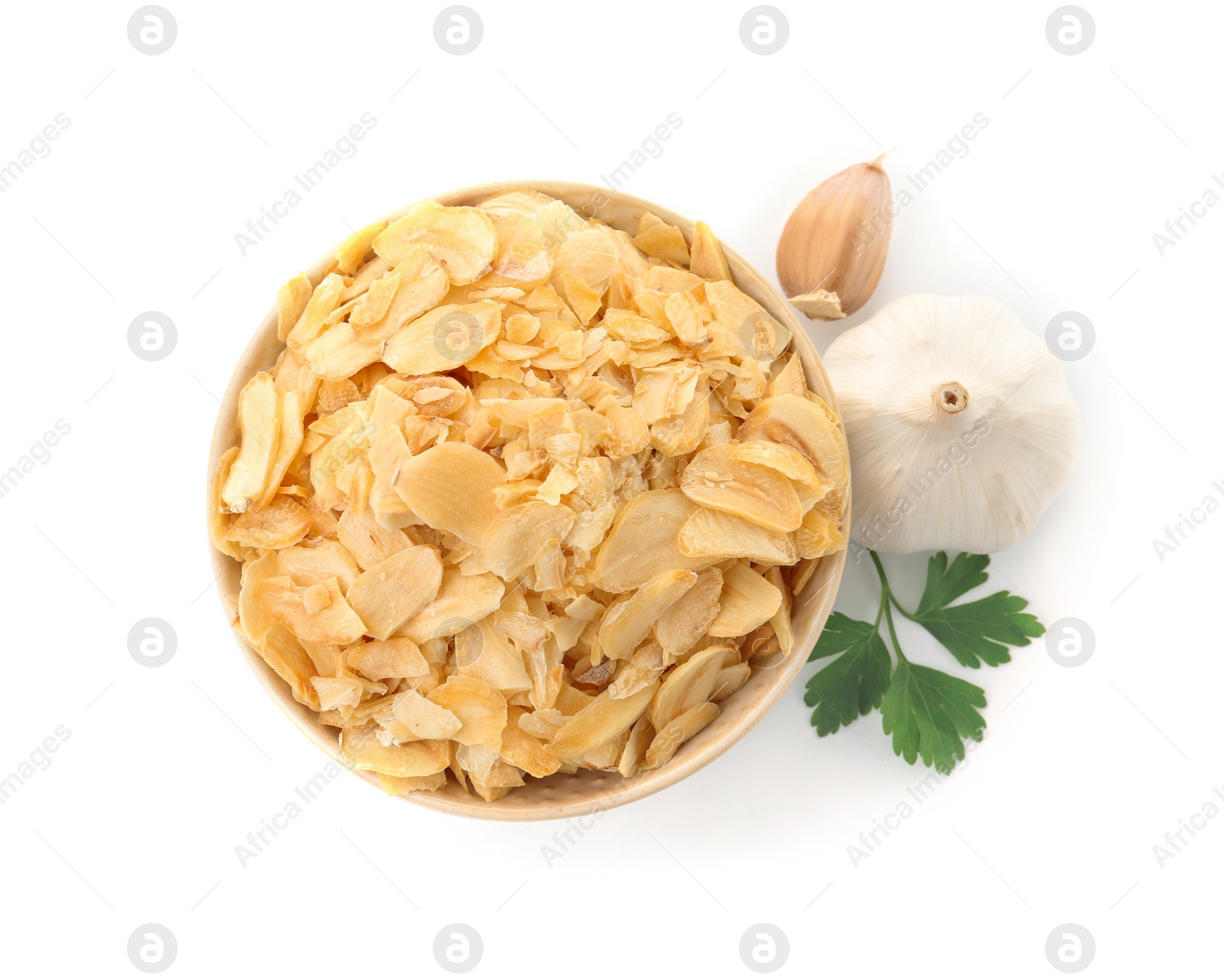 Photo of Bowl of dried garlic flakes and parsley on white background, top view