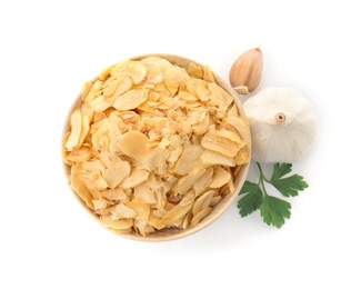 Bowl of dried garlic flakes and parsley on white background, top view