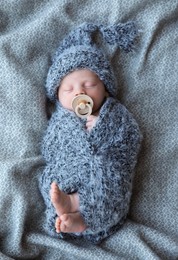 Photo of Cute newborn baby sleeping on blanket, top view