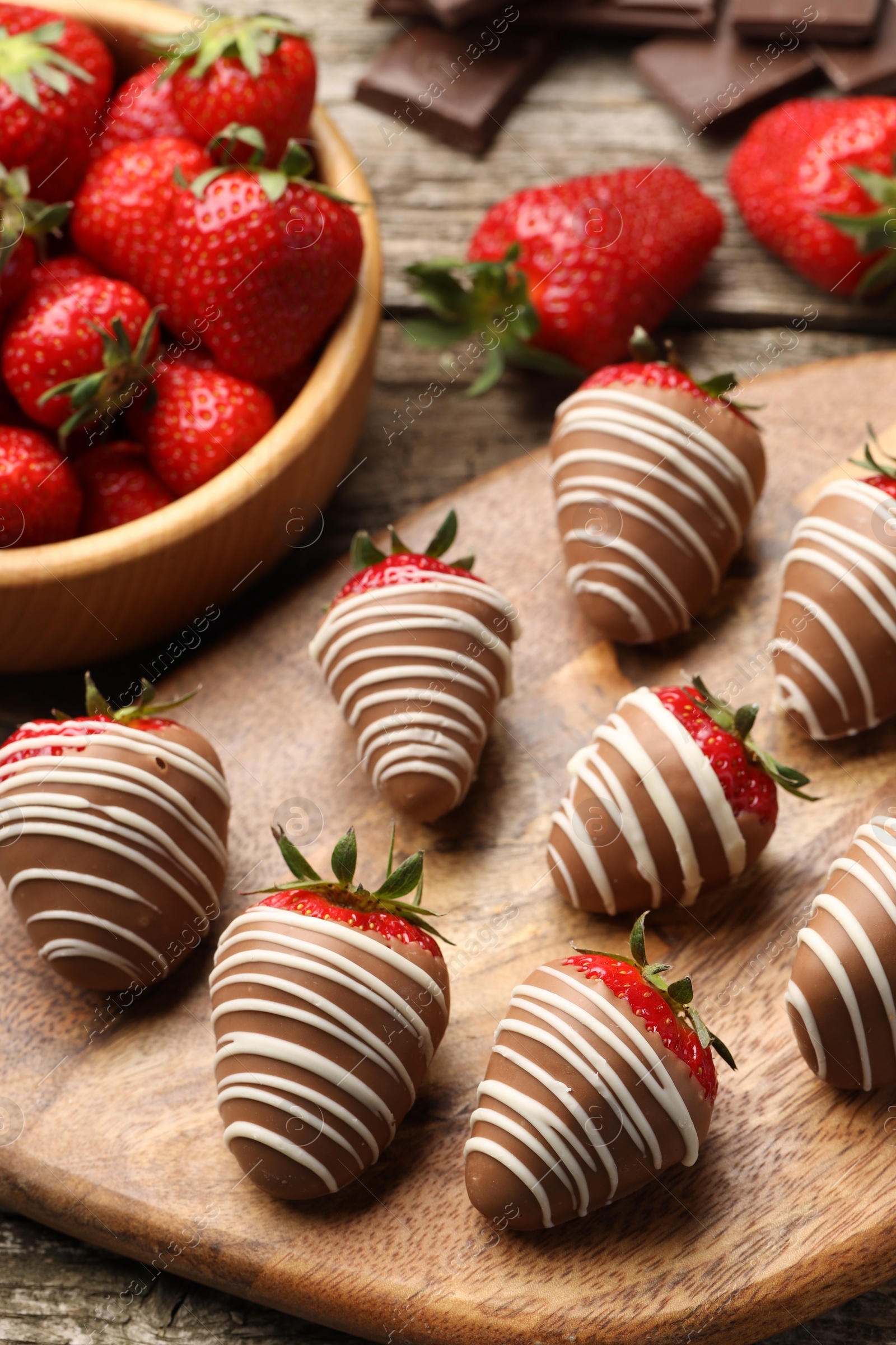 Photo of Delicious chocolate covered strawberries on wooden table, closeup