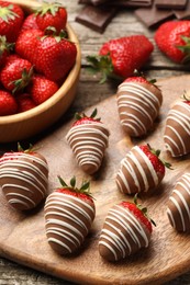 Photo of Delicious chocolate covered strawberries on wooden table, closeup