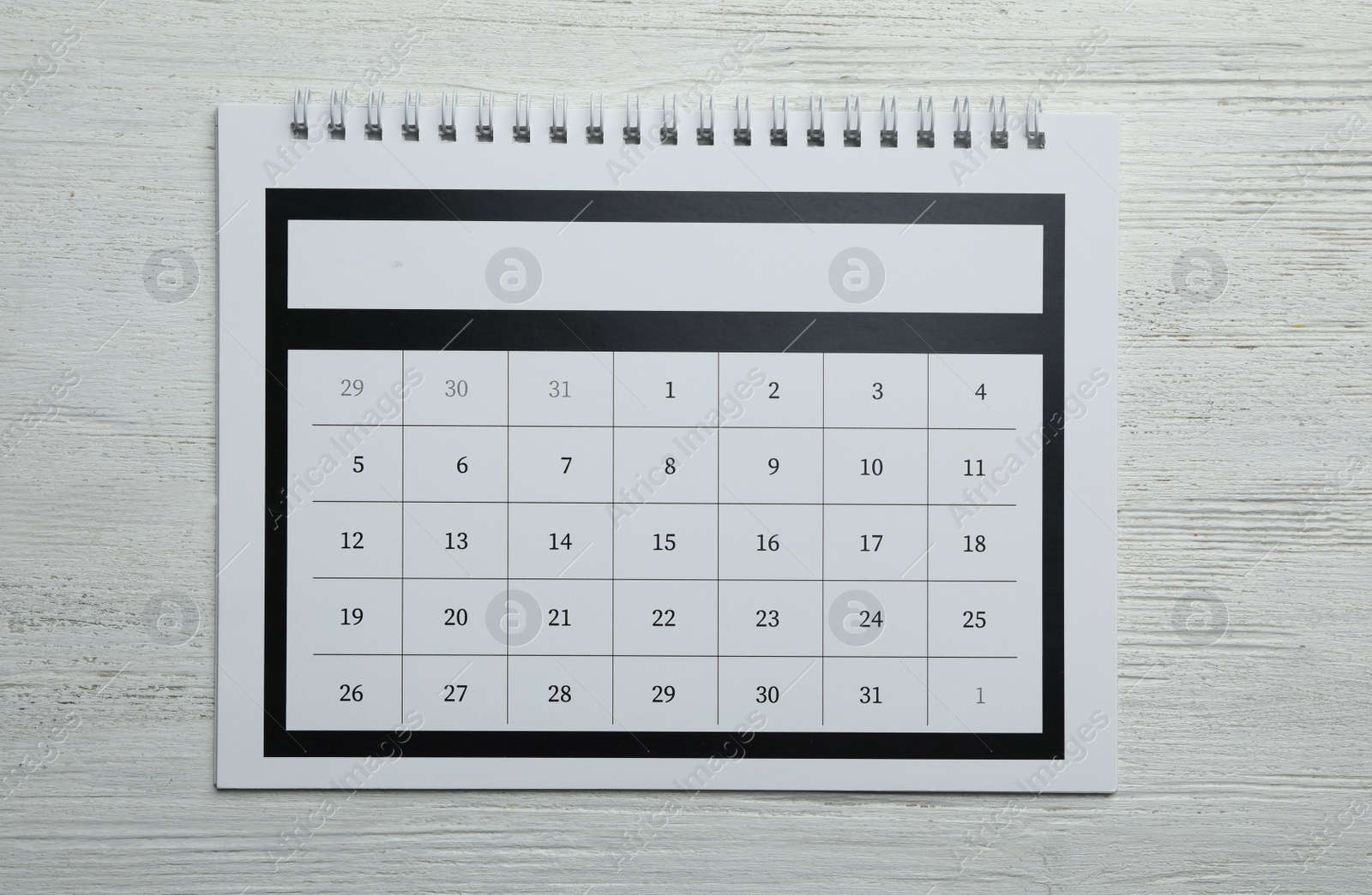 Photo of Paper calendar on white wooden background, top view