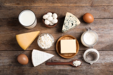 Photo of Different dairy products on wooden table, flat lay