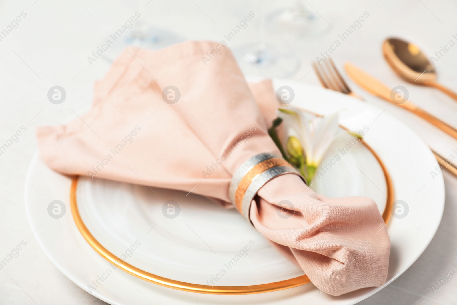 Photo of Festive table setting with linen napkin on plates, closeup