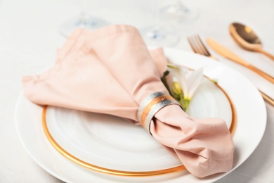 Festive table setting with linen napkin on plates, closeup