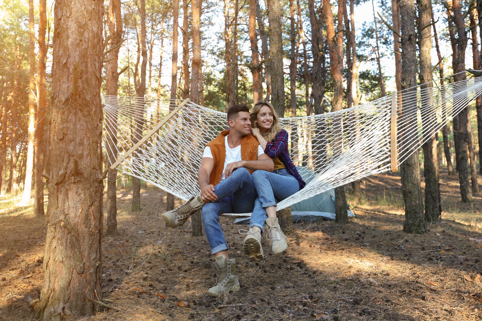 Photo of Happy couple resting in hammock outdoors on summer day