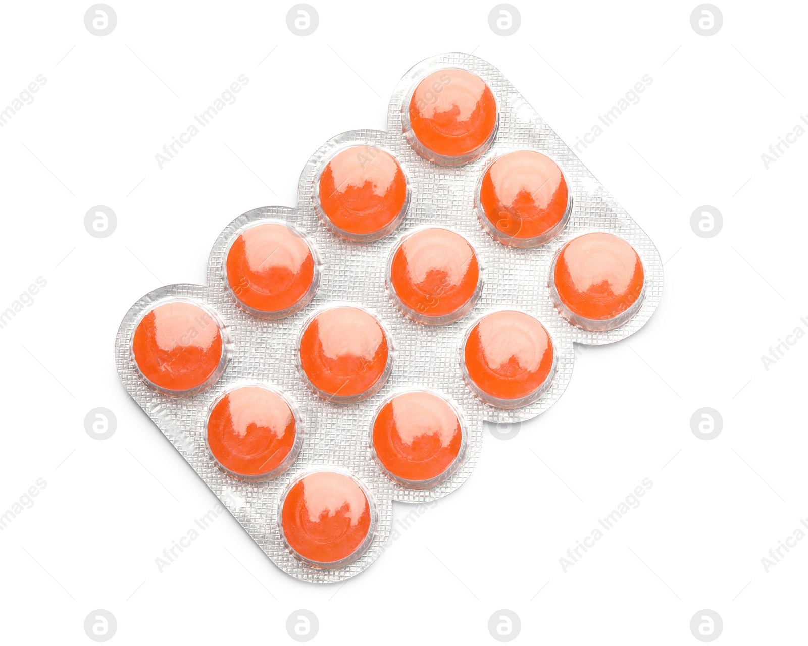 Photo of Blister with orange cough drops on white background, top view