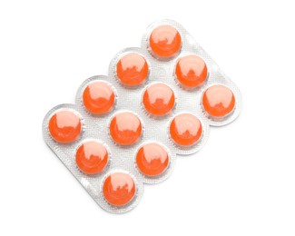 Blister with orange cough drops on white background, top view