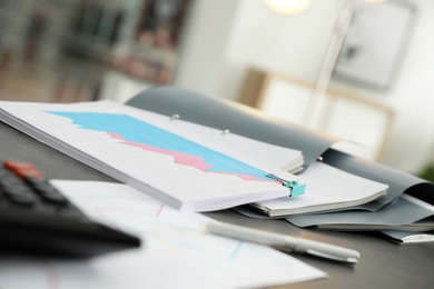 Open folders with documents on office table