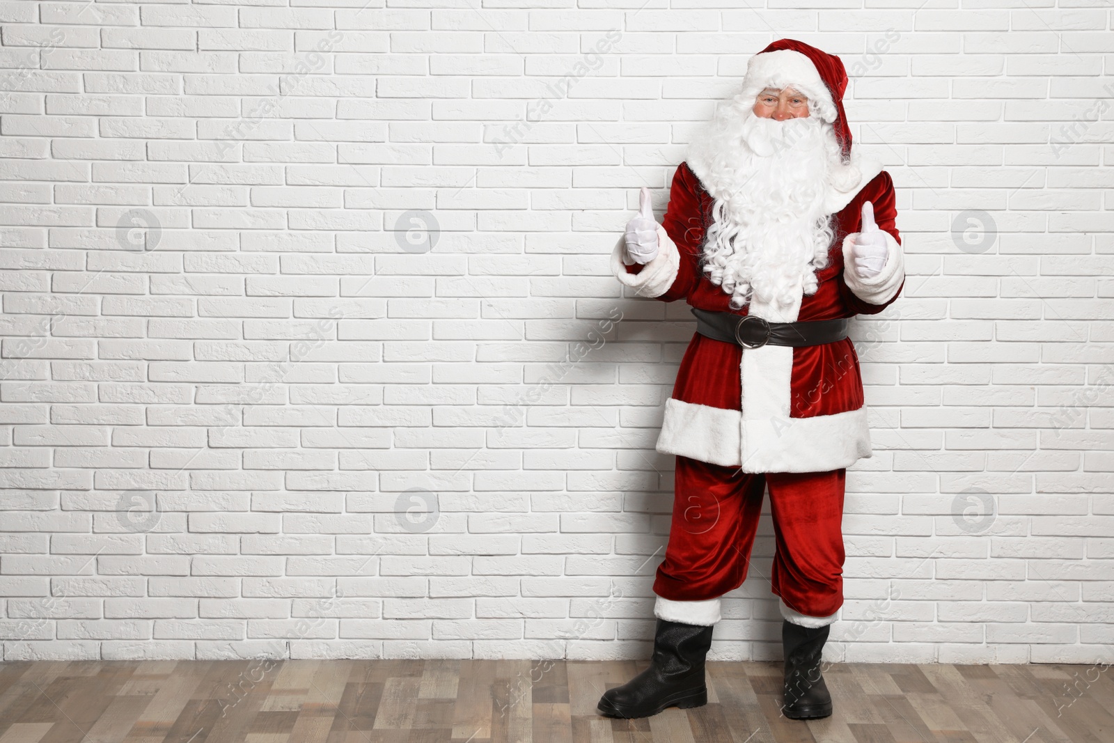 Photo of Authentic Santa Claus against white brick wall. Space for text