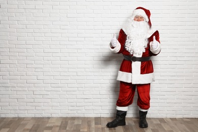Authentic Santa Claus against white brick wall. Space for text