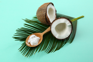 Photo of Composition with organic coconut oil on turquoise background. Healthy cooking