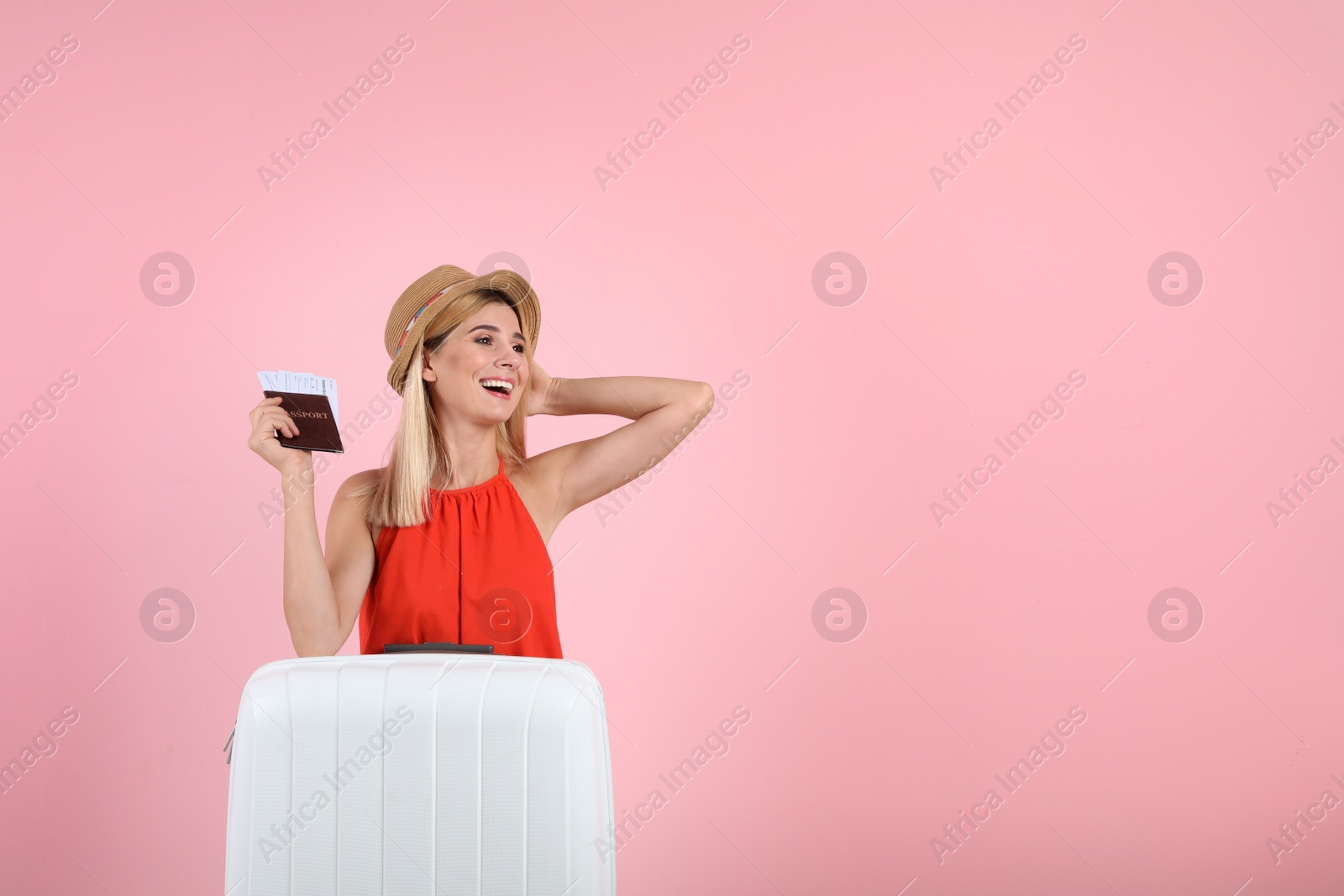 Photo of Woman with suitcase and passport on color background. Space for text