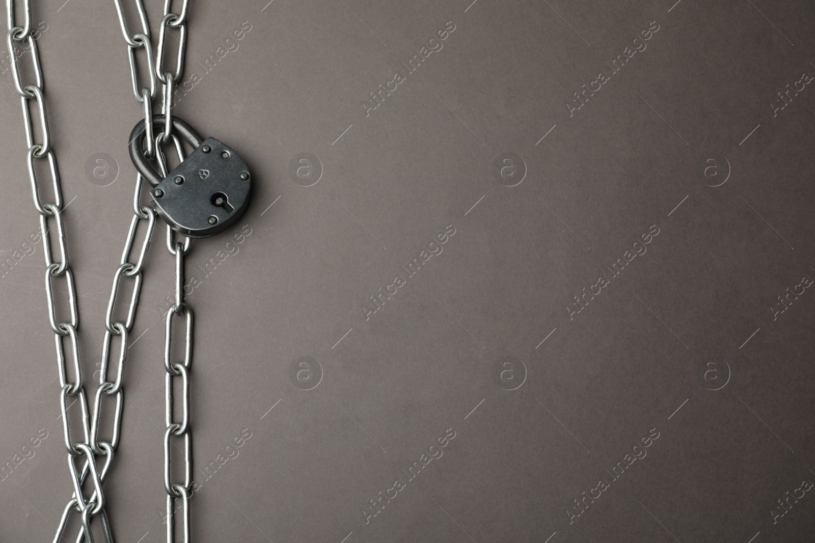 Photo of Steel padlock, chains and space for text on grey background, flat lay. Safety concept