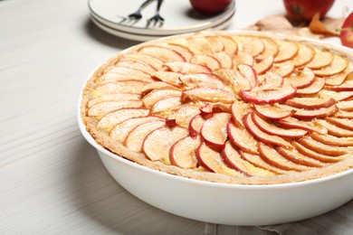 Photo of Tasty apple pie on white wooden table, closeup